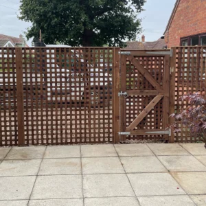 privacy trellis used as fencing with a custom gate to match